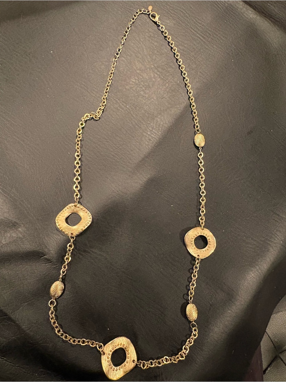 Long Gold Tone Womenโs Necklace with Textured Open Circle Accents